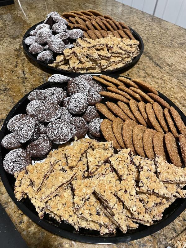 Platters of powdered chocolate crinkle cookies, thin crisp cookies and nut-topped bars