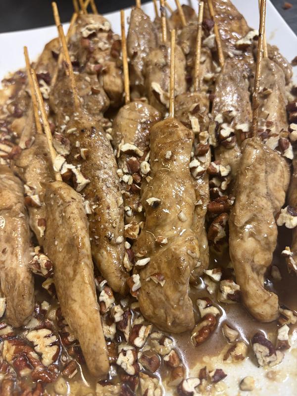 Butter pecan chicken skewers sprinkled with chopped pecans