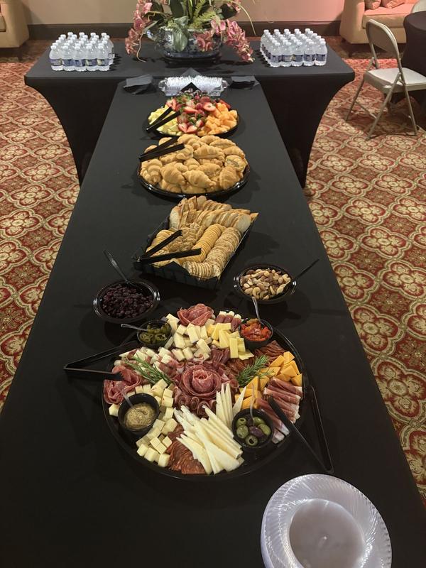 Long buffet table draped in black linens