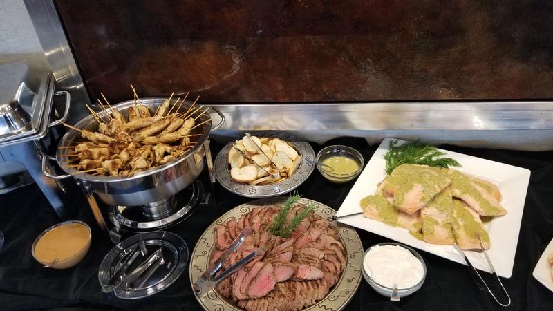 Event buffet with sliced beef, salmon and a chafing dish