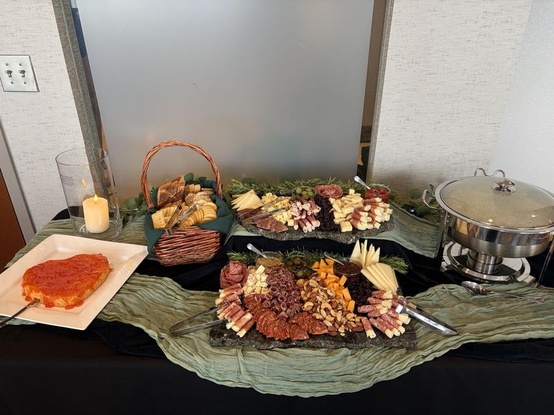 Charcuterie spread with bread baskets on a draped table
