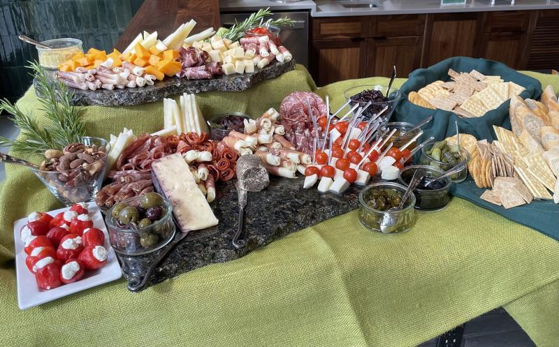 Charcuterie display on a green tablecloth