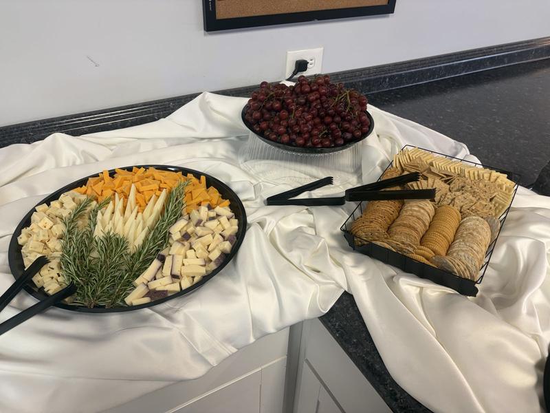 Cheese platter with crackers and grapes