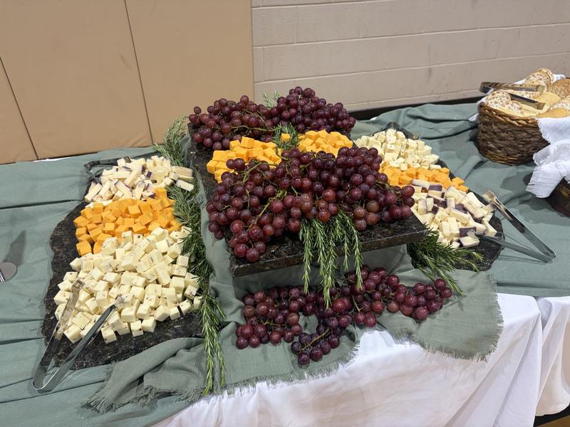 Display of cheeses and grapes