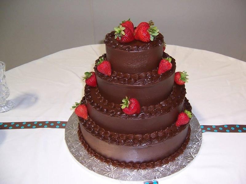 Tiered chocolate cake topped with strawberries