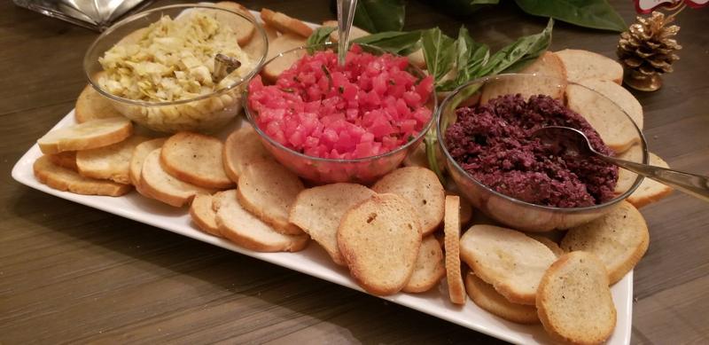 Platter of crostini served with a trio of bruschetta toppings