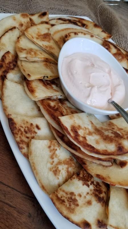Chicken quesadilla wedges served with a creamy dip