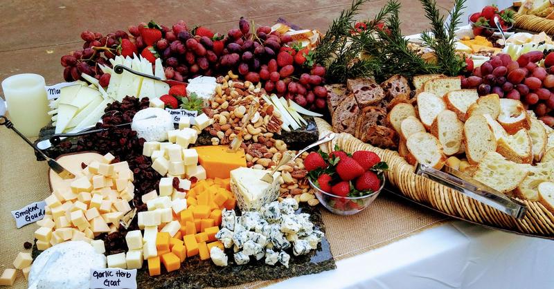 Grazing spread of cheeses, crackers, fruit and nuts