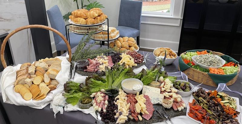 Abundant grazing table with charcuterie, bread and vegetables