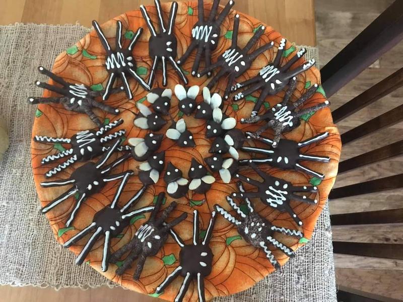 Round Halloween dessert decorated with chocolate spiders