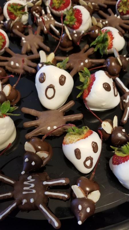 Chocolate-dipped strawberries decorated as ghosts and spiders