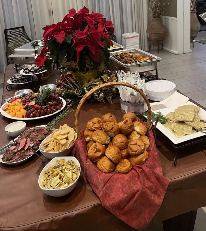 Holiday buffet with a basket of bread beside a poinsettia