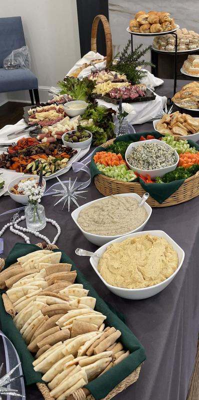 Catered holiday buffet with dips, bread and platters