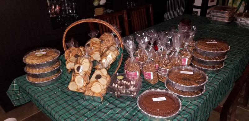 Table of pies and bagged treats on a green tablecloth