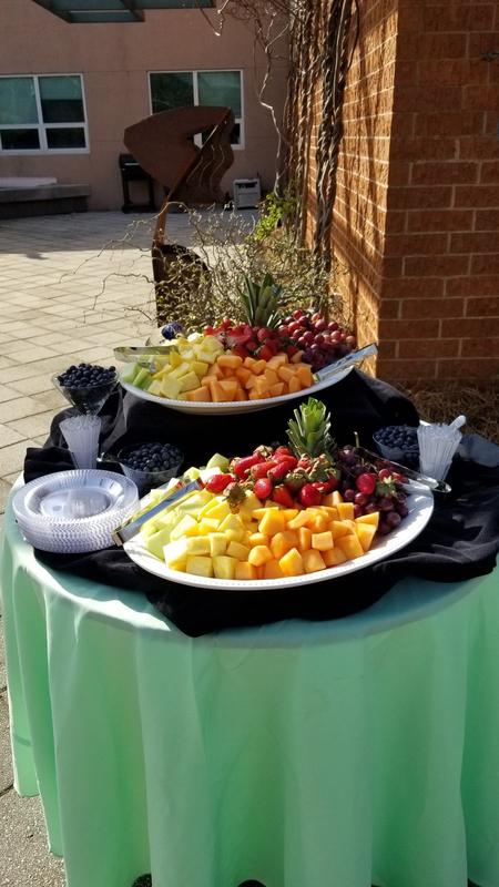 Outdoor event table with platters of fresh fruit
