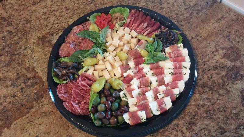 Round platter of cured meats, cheeses and olives