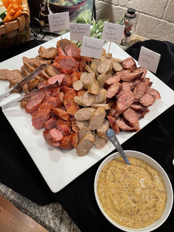 Platter of assorted sliced sausages served with honey mustard