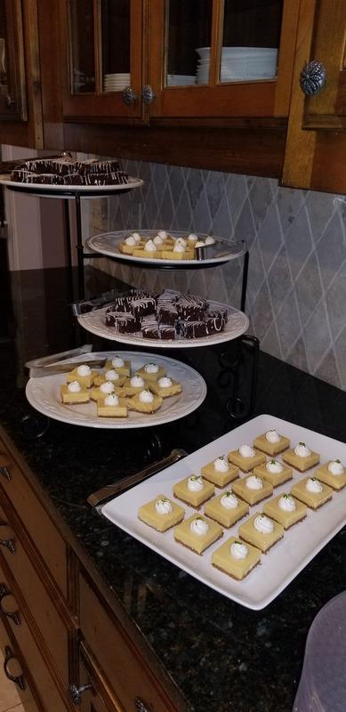 Tiered stands of assorted desserts on a kitchen counter