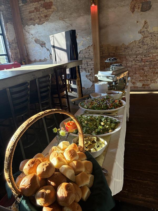 Catered buffet with a basket of bread rolls