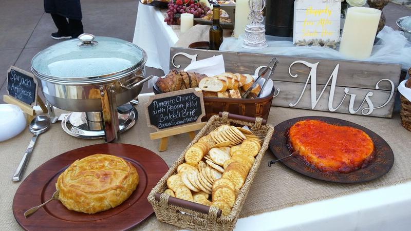 Wedding buffet table with a chafing dish and crackers beside a Mr and Mrs sign