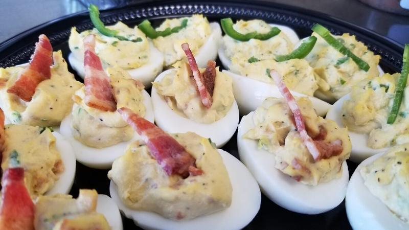 Deviled eggs topped with crisp bacon