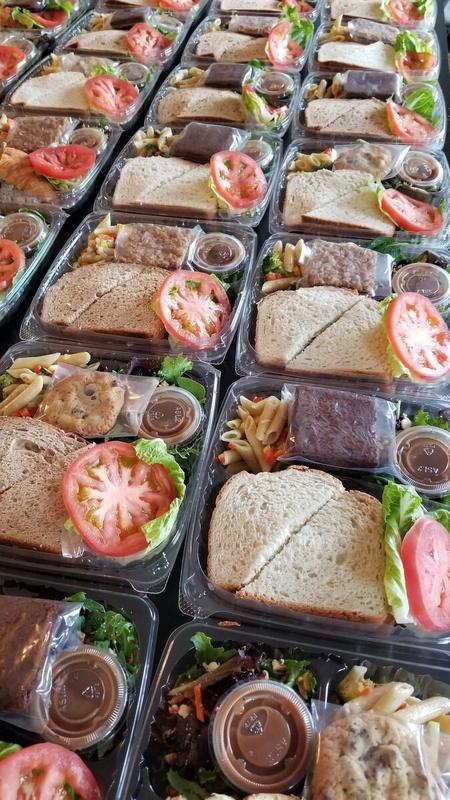 Boxed lunches with sandwiches, fresh fruit and cookies
