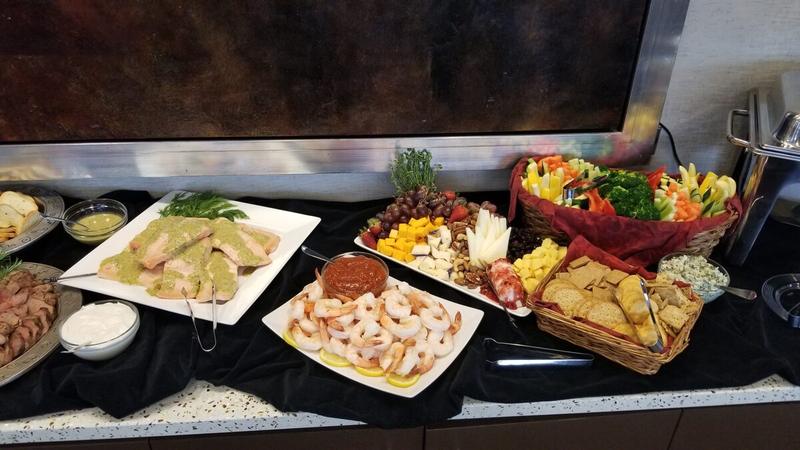 Elegant event buffet with salmon, shrimp cocktail and sliced beef tenderloin