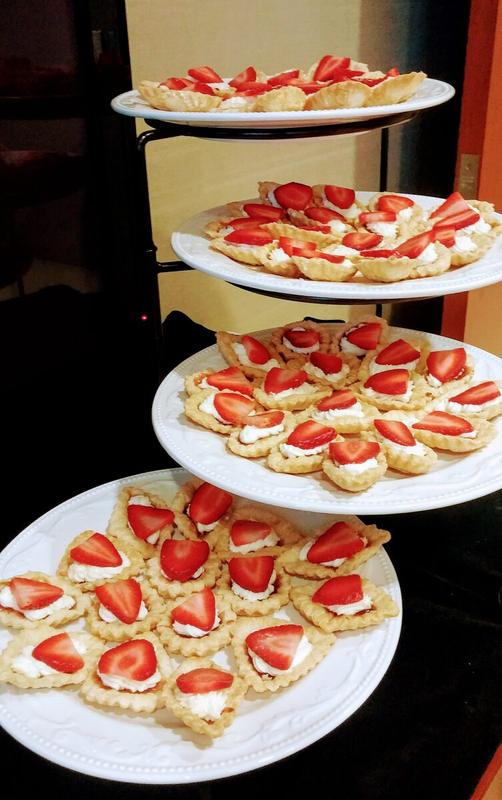 Tiered stands of strawberry cream tartlets