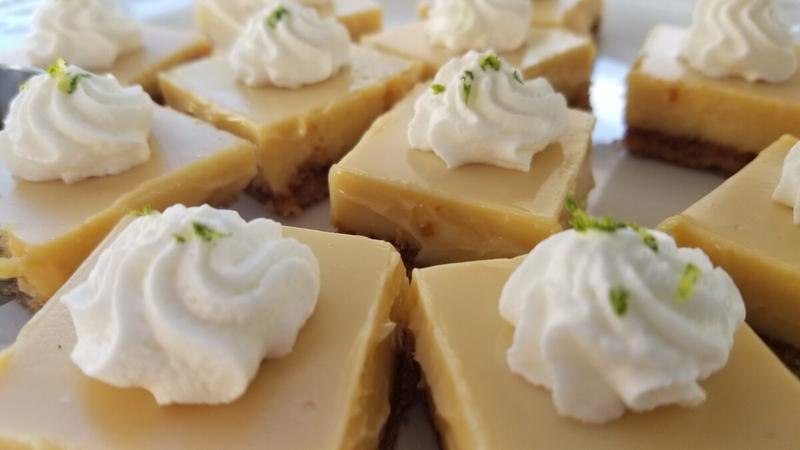 Key lime squares topped with whipped cream