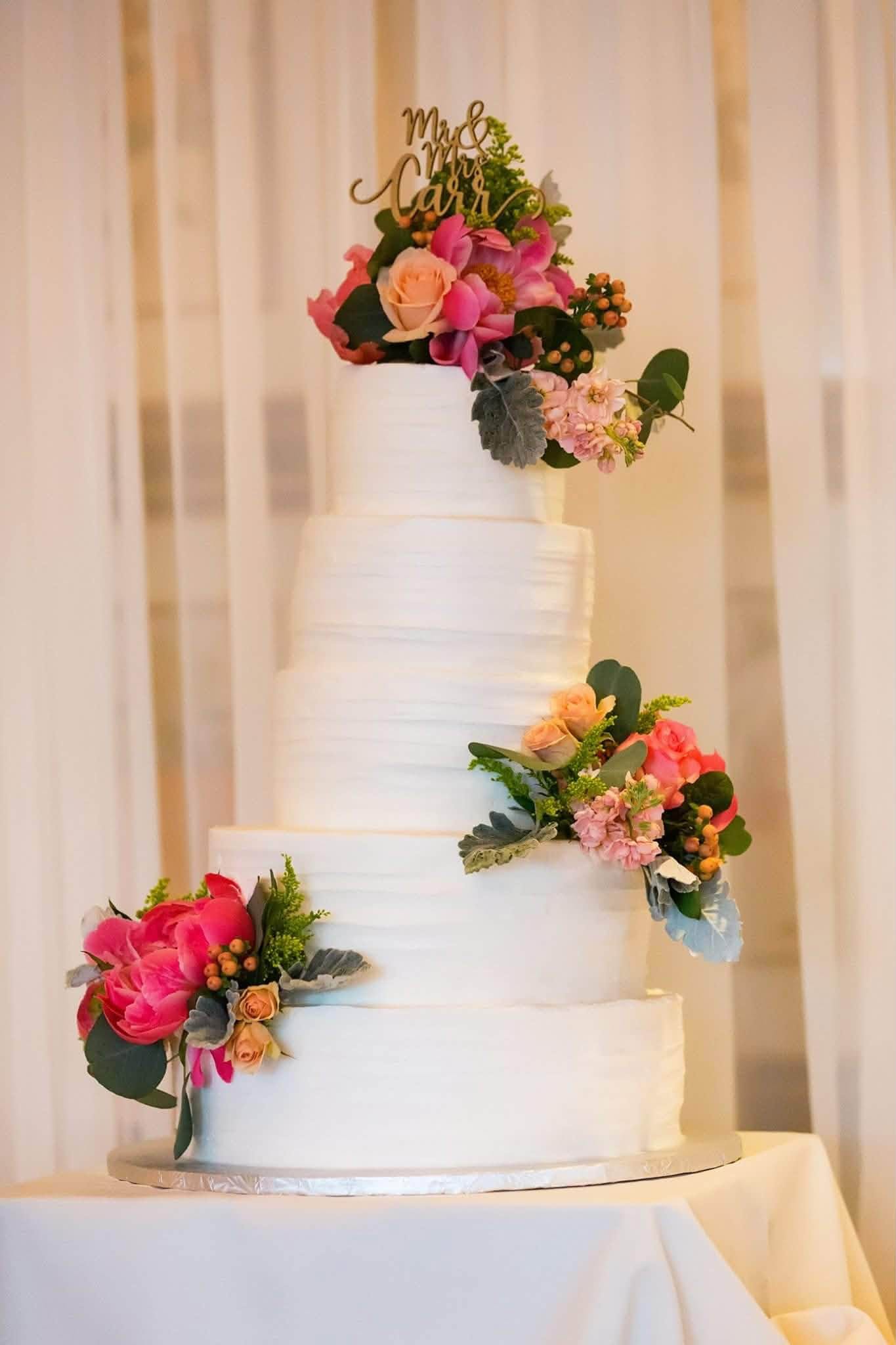 Elegant tiered celebration cake decorated with fresh flowers